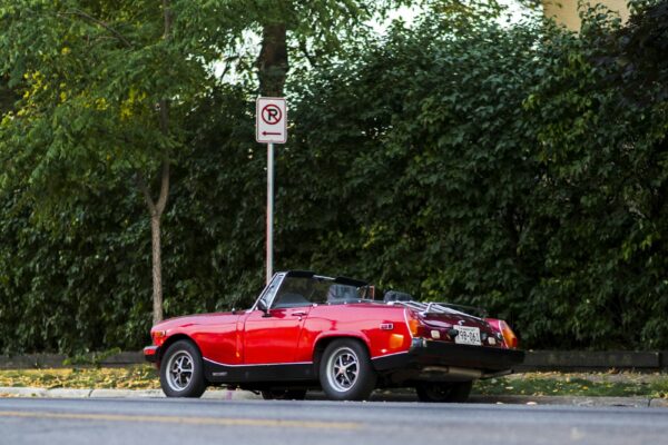 Red sports car parked on the roadside