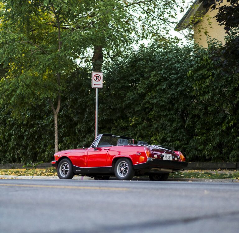Red sports car parked on the roadside