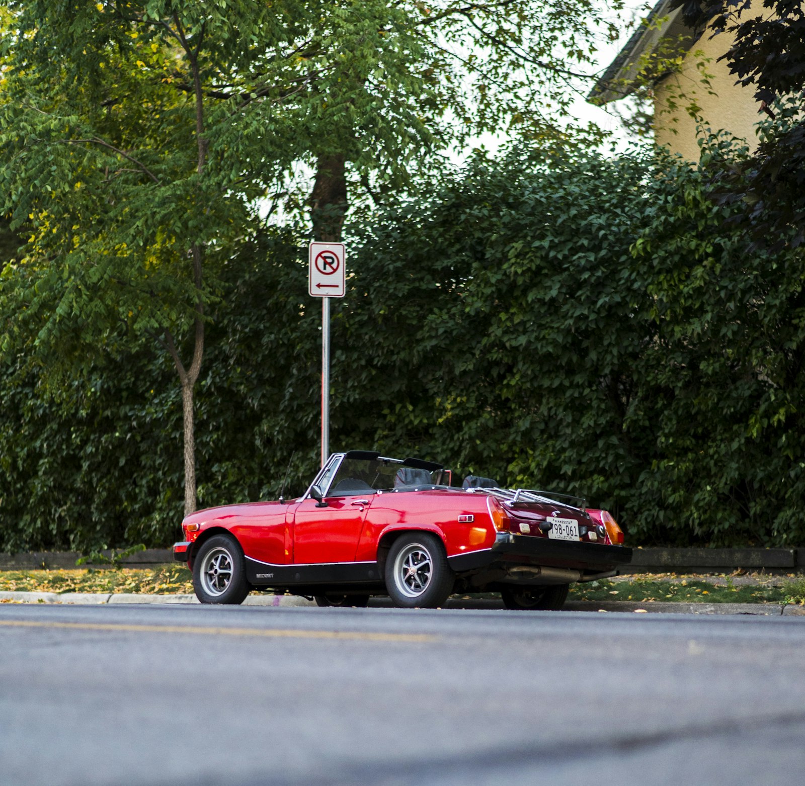 Red sports car parked on the roadside