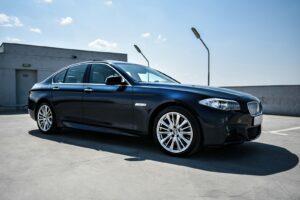 Black luxury sedan parked on a street