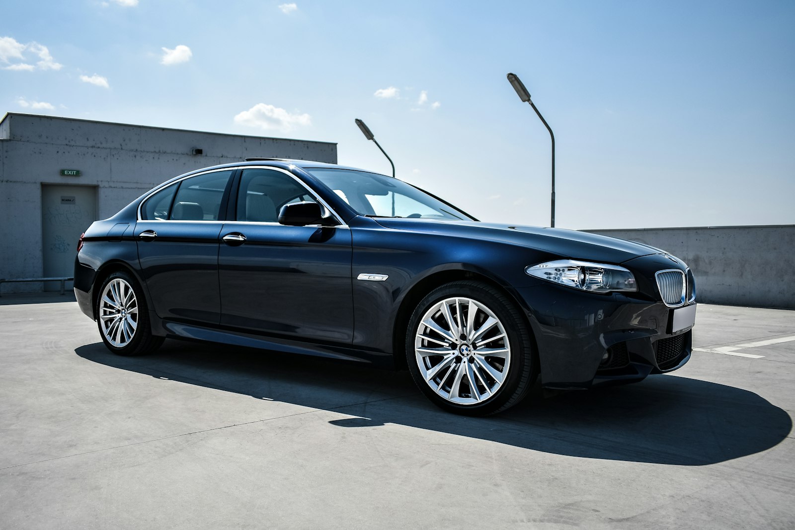 Black luxury sedan parked on a street
